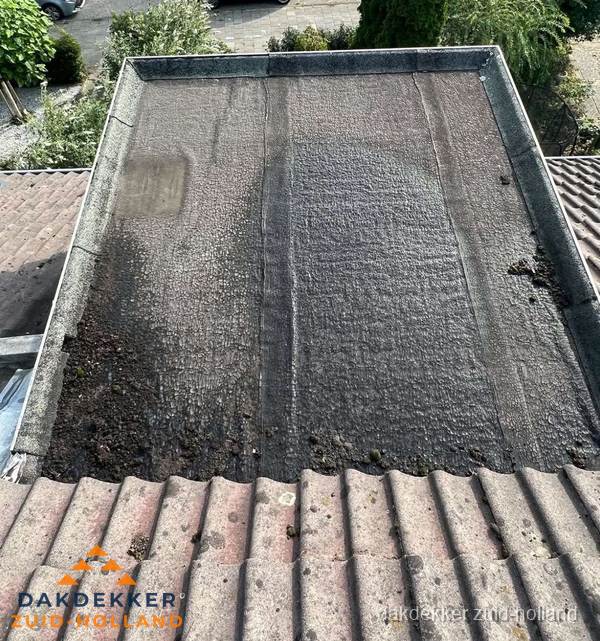 Verouderd plat dak met bitumen en slijtage voor lekkage inspectie in Zuid-Holland