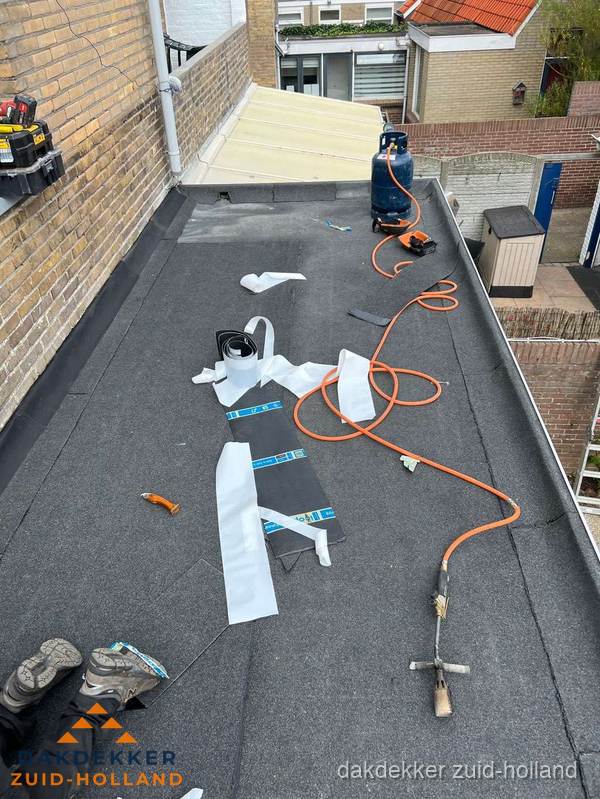 Dakdekkers bezig met bitumen dakbedekking in Zuid-Holland
